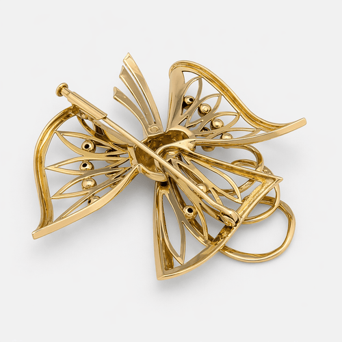 Broche Broche nœud stylisé en or jaune 18 carats, diamants et émeraudes 58 Facettes 36314