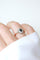 Bague 61 Bague marguerite ancienne en or rose, platine, saphir et diamants 58 Facettes