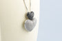 Collier Collier double cœur en or blanc 18K et diamants 58 Facettes CLDIAMBLACK-107