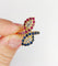 Bague 52.5 Bague marquise moderniste en or 18k, diamants, rubis et saphirs 58 Facettes A07270