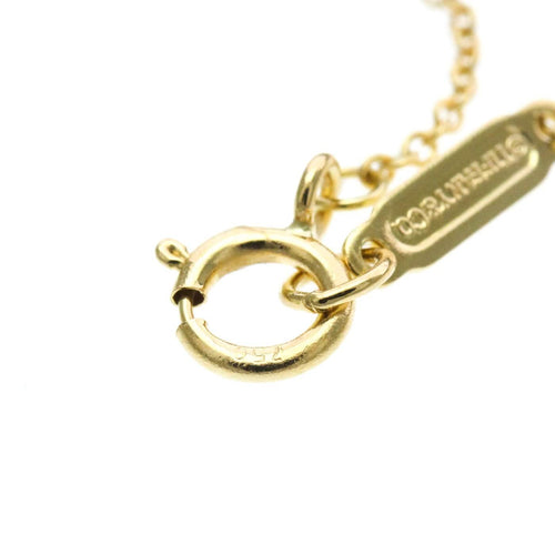 Collier Tiffany & Co. - Collier pendentif Letter Disc en or jaune 18K 58 Facettes tvg2iyp7ie