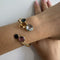 Bracelet Bracelet rigide contrarié en or jaune et pierres précieuses 58 Facettes 41831