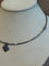 Collier Pomellato - Collier rigide croix en or gris bruni et saphirs 58 Facettes 34200002