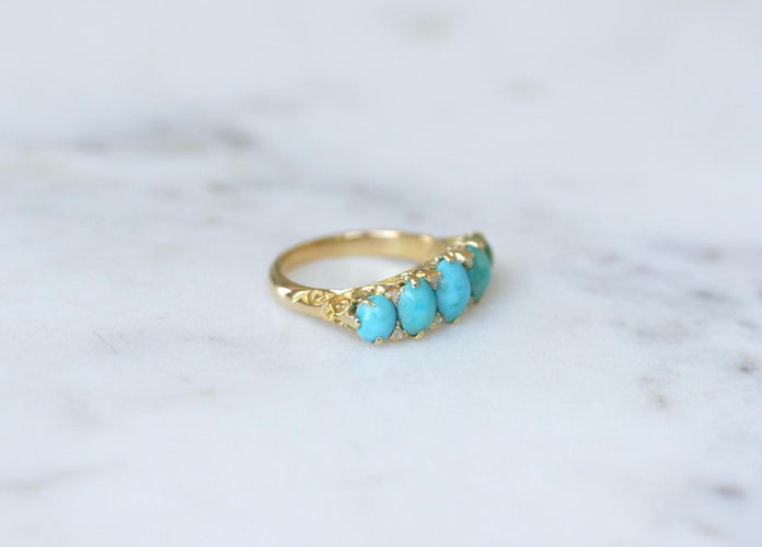 Bague 53 Bague jarretière en or jaune, turquoises et diamants 58 Facettes