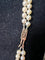 Collier Collier double rang Akoya en or jaune, grenats et diamants 58 Facettes 933