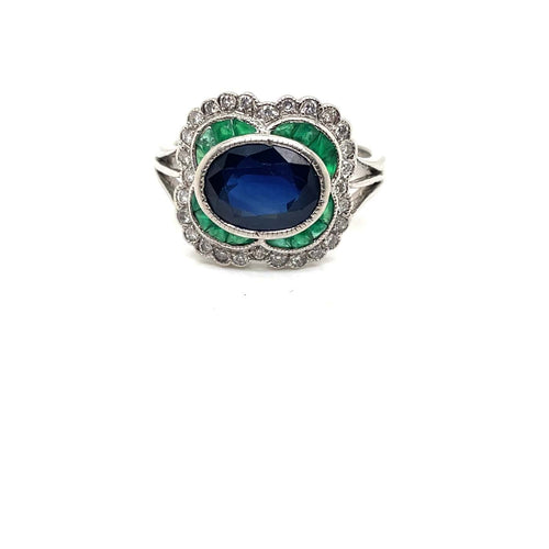 53.5 Bague marguerite en or blanc, saphir, émeraudes et diamants 58 Facettes 00946