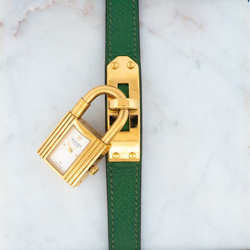 Hermès Kelly - Montre en acier plaqué or, cadran ivoire 58 Facettes 563