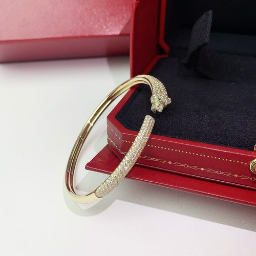 Cartier Panthère - Bracelet en or jaune, diamants, émeraudes et onyx 58 Facettes jnci167