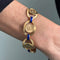 Bracelet Bracelet vintage émaillé à pièces Dos Pesos en or jaune 18 ct 58 Facettes 36092