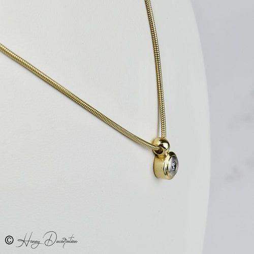 Collier Collier chaîne serpent en or 14 carats avec pendentif bicolore et diamant 58 Facettes 2036