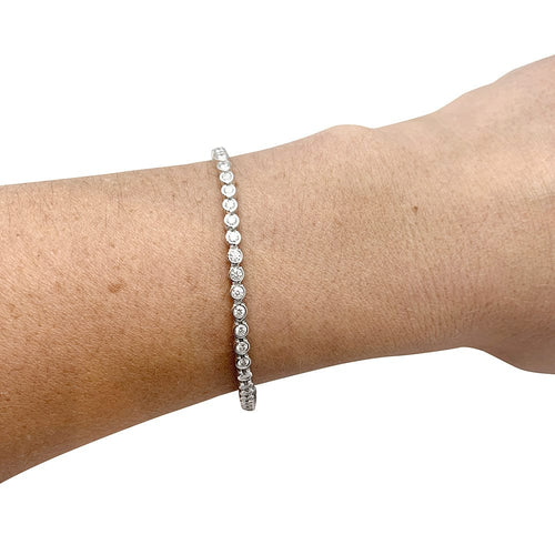 Bracelet Bracelet ligne Cartier "C de Cartier" en or blanc et diamants. 58 Facettes 30089
