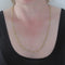 Collier Collier or personnages entrelacés 58 Facettes 12-037