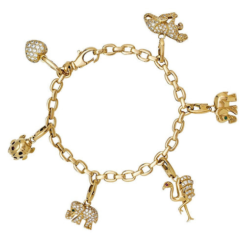 Bracelet Bracelet Cartier en or jaune, 6 breloques, diamants, émeraudes et rubis. 58 Facettes 30849/55