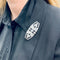 Broche Broche Art Déco en platine sertie de diamants et d'onyx. 58 Facettes 32080
