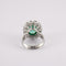Bague 49 Bague Marguerite en or gris, émeraude, diamants 58 Facettes
