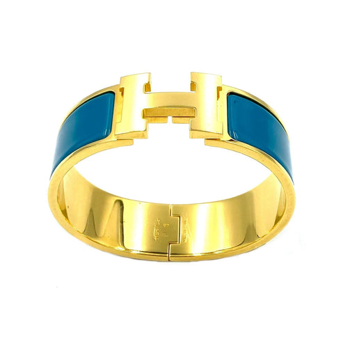 Bracelet HERMÈS. Bracelet métal doré et émail 58 Facettes