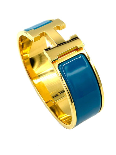 Bracelet HERMÈS. Bracelet métal doré et émail 58 Facettes